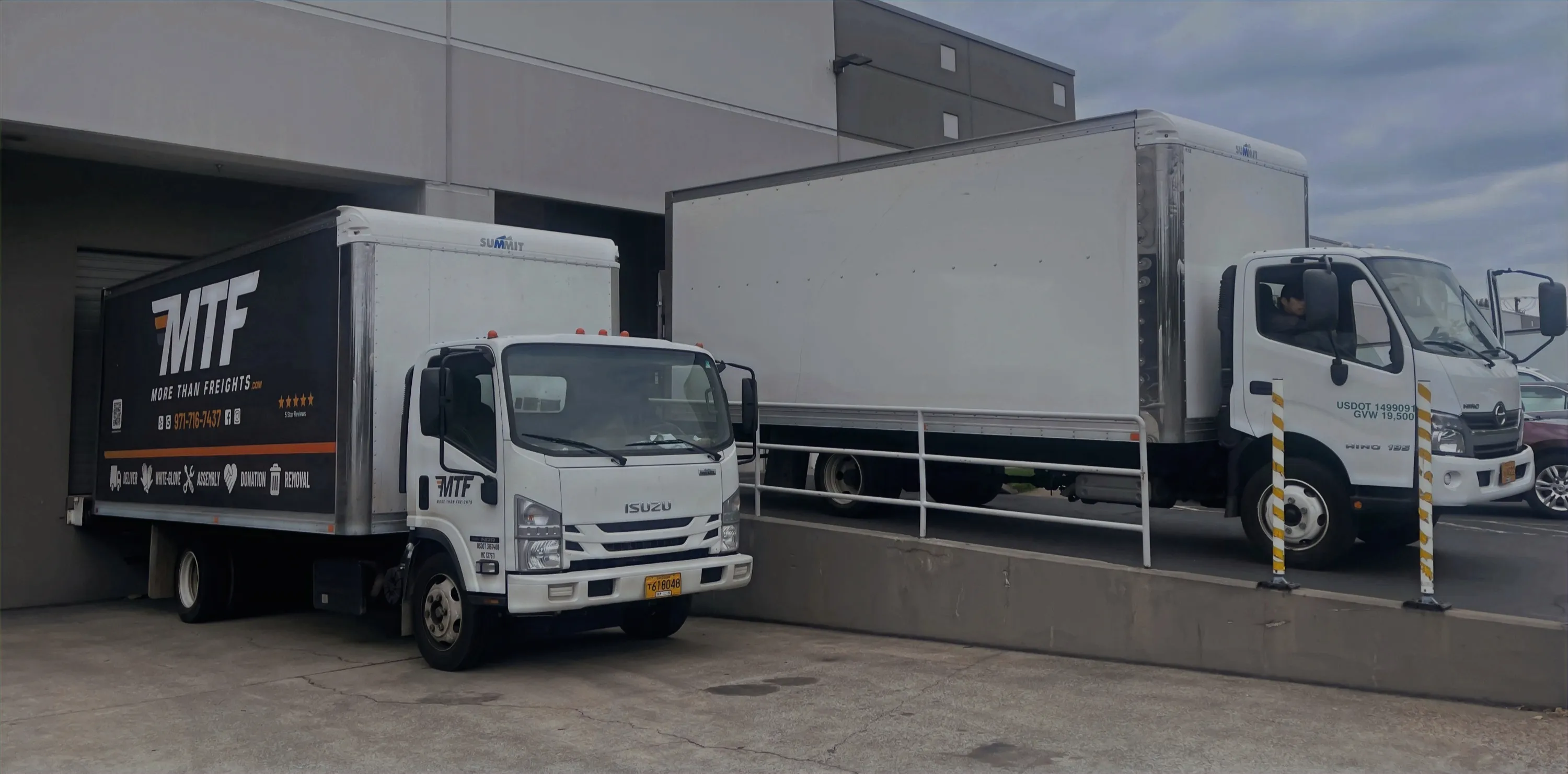 Two More Than Freights box trucks parked at a loading dock