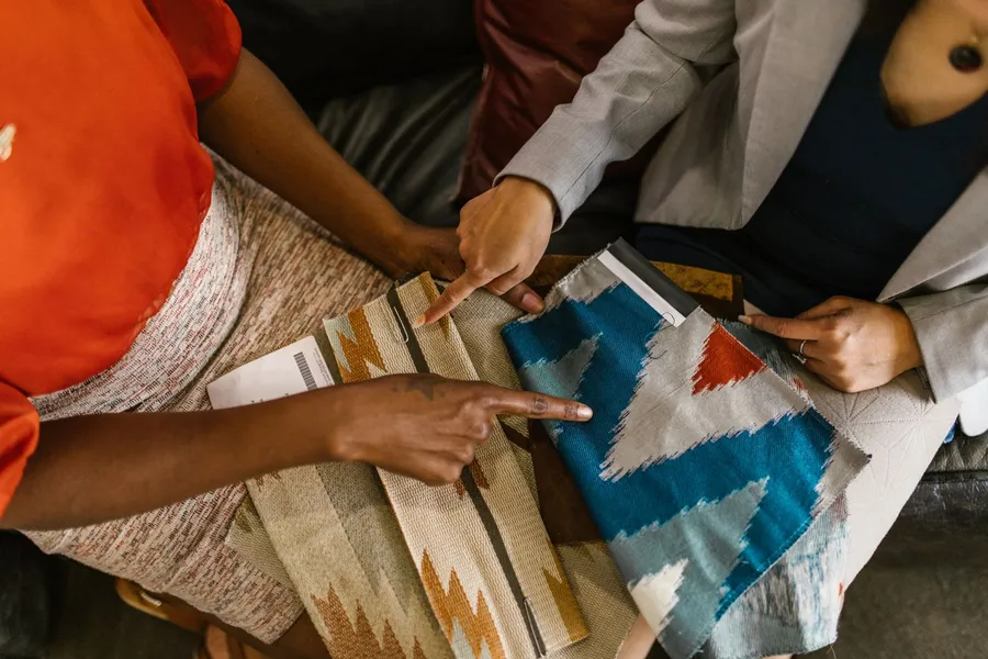 Interior designers reviewing fabric swatches for a design project