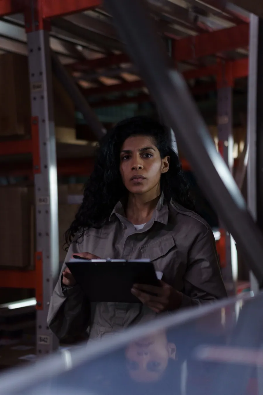 Warehouse worker checking incoming inventory against a clipboard