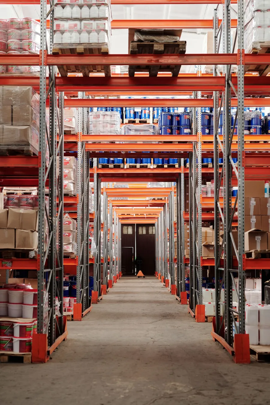 Organized warehouse aisle with pallet racking and stored goods